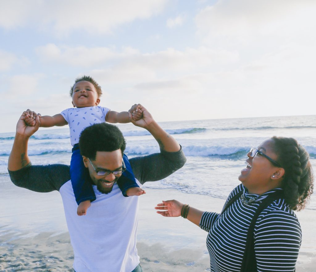 Parents laughing and engaging in activities with children
